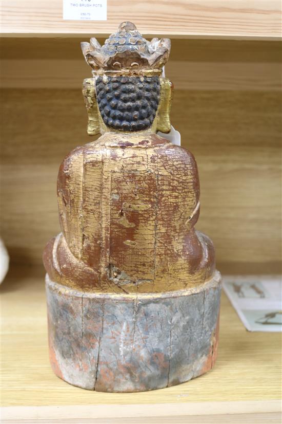 A Chinese gilt and polychrome wood seated figure of Buddha height 32cm